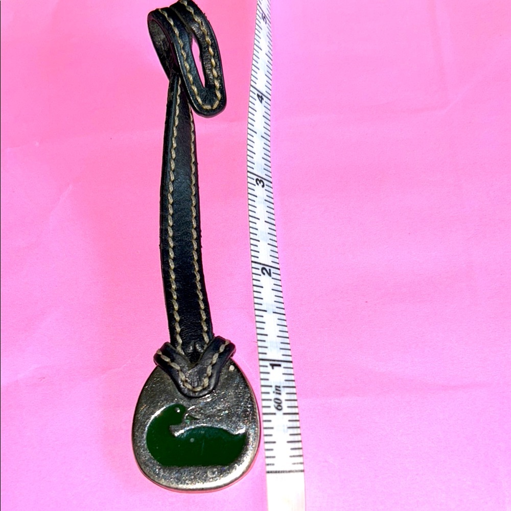 Dooney & Bourke black leather strap with silver fob and black duck